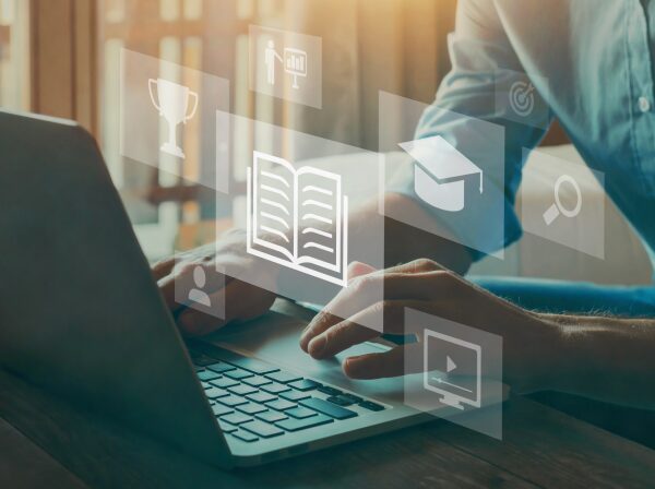 typing on laptop with icons in the air