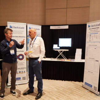 attendee and sponsor speaking at a booth